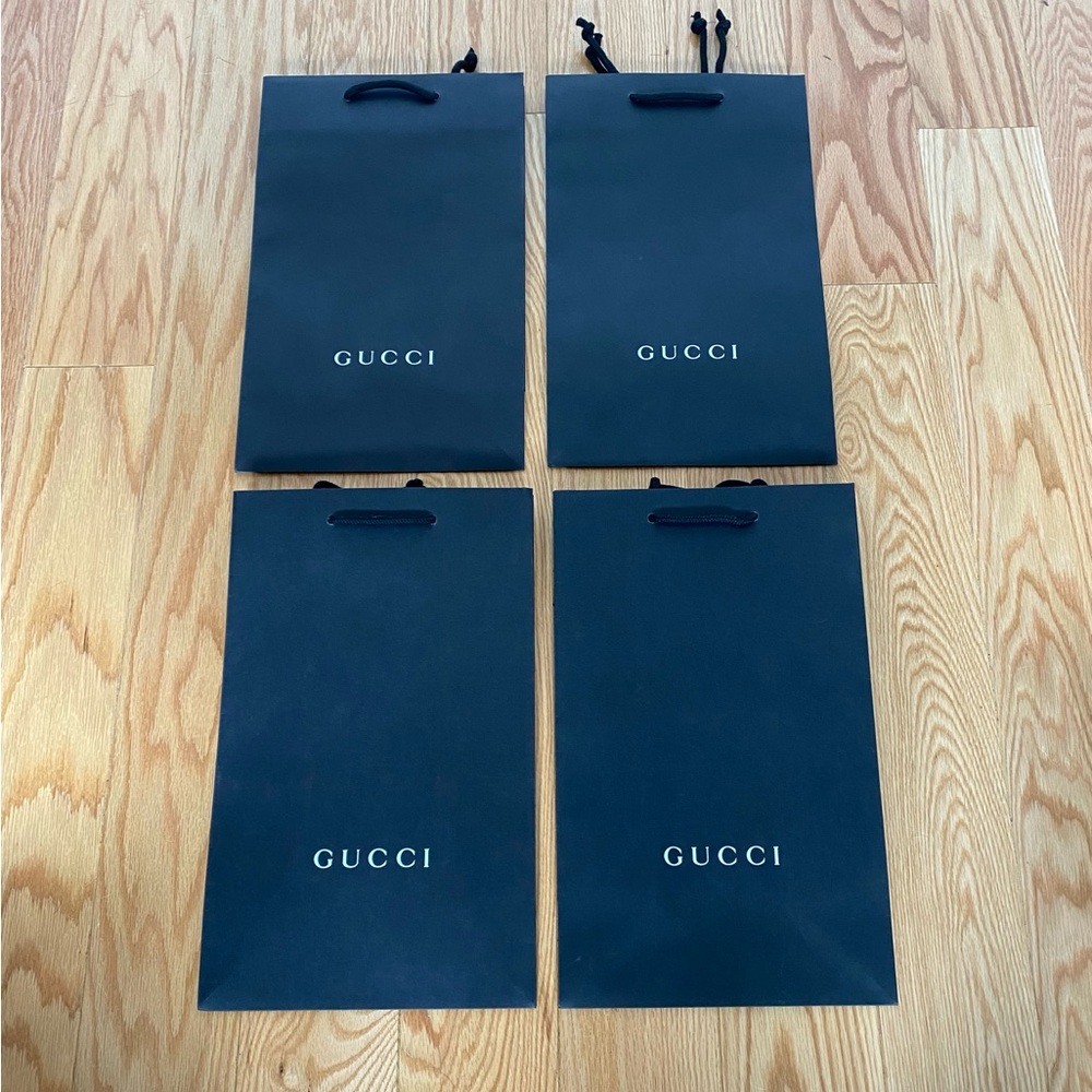 Four authentic Gucci paper bags